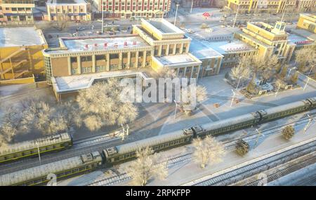 200110 -- ERENHOT, Jan. 10, 2020 -- Aerial photo taken on Jan. 9, 2020 shows train No. 6856 stopping at Erenhot Railway Station in north China s Inner Mongolia Autonomous Region. Train No. 6856, connecting Erenhot and Hohhot, runs a distance of 491 kilometers and stops at 28 stations during the 8-hour trip. The cheap ticket price is not the only reason why local people favor the train. Living on the vast prairie, local herdsmen and farmers may encounter a lot of problems in terms of shopping and medical service. To better serve people along the route, the train is equipped with various medical Stock Photo