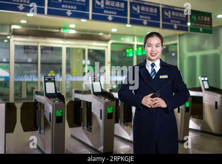 200111 -- WUHAN, Jan. 11, 2020 -- Sun Fanjun, a ticket inspector, poses for a photo at Hankou Railway Station in Wuhan, central China s Hubei Province, Jan. 5, 2020. China, the world s most populated country, on Jan. 10 ushered in its largest annual migration, 15 days ahead of the Spring Festival, or the Lunar New Year. This year, three billion trips will be made during the travel rush from Jan. 10 to Feb. 18 for family reunions and travel, according to official forecast. The 40-day travel rush is known as Chunyun in Chinese. The Lunar New Year falls on Jan. 25 this year, earlier than previous Stock Photo