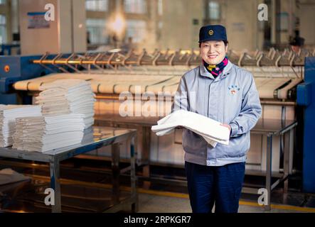 200111 -- WUHAN, Jan. 11, 2020 -- Wang Erling, a washing worker for train bedding, poses for a photo at the washing center of Wuhan Passenger Transport Department in Wuhan, central China s Hubei Province, Jan. 6, 2020. China, the world s most populated country, on Jan. 10 ushered in its largest annual migration, 15 days ahead of the Spring Festival, or the Lunar New Year. This year, three billion trips will be made during the travel rush from Jan. 10 to Feb. 18 for family reunions and travel, according to official forecast. The 40-day travel rush is known as Chunyun in Chinese. The Lunar New Y Stock Photo
