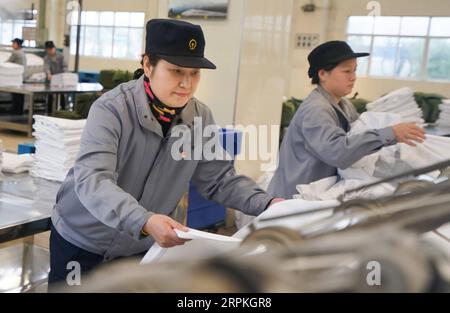200111 -- WUHAN, Jan. 11, 2020 -- Wang Erling L, a washing worker for train bedding, arranges the freshly ironed bedding at the washing center of Wuhan Passenger Transport Department in central China s Hubei Province, Jan. 6, 2020. China, the world s most populated country, on Jan. 10 ushered in its largest annual migration, 15 days ahead of the Spring Festival, or the Lunar New Year. This year, three billion trips will be made during the travel rush from Jan. 10 to Feb. 18 for family reunions and travel, according to official forecast. The 40-day travel rush is known as Chunyun in Chinese. Th Stock Photo