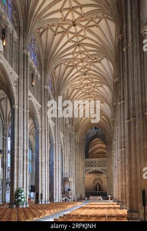 The nave of Canterbury Cathedral, view from west entrance. A priest in the pulpit speaks to an empty church. Stock Photo