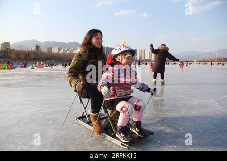 200113 -- BEIJING, Jan. 13, 2020 -- People have fun on a frozen lake in Mentougou District of Beijing, capital of China, Jan. 12, 2020. Photo by /Xinhua CHINA-WINTER-OUTDOORS-FUN CN HouxJiqing PUBLICATIONxNOTxINxCHN Stock Photo