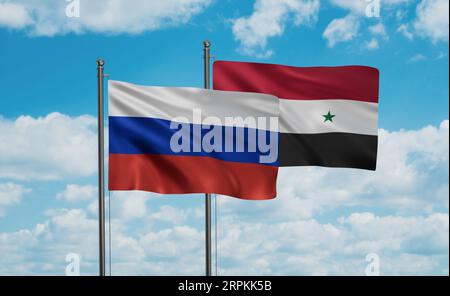 Syrian Arab Republic, Syria and Russia flag waving together in the wind on blue sky, two country cooperation concept Stock Photo