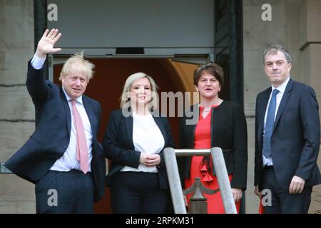 200113 -- BELFAST, Jan. 13, 2020 Xinhua -- British Prime Minister Boris Johnson 1st L and British Secretary of State for Northern Ireland Julian Smith 1st R are greeted by Northern Ireland First Minister Arlene Foster 2nd R of the Democratic Unionist Party DUP and Deputy First Minister Michelle O Neill of Sinn Fein in Belfast, Northern Ireland, the United Kingdom, on Jan. 13, 2020. Boris Johnson said Monday during a visit to Belfast, Northern Ireland that he hopes and is confident to secure a zero-tariff, zero-quota agreement with the European Union EU. Photo by Paul McErlane/Xinhua UK-BELFAST Stock Photo