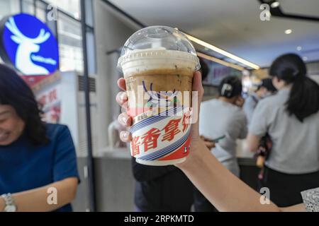 Luckin Coffee, the domestic coffee chain house, collaborates with liquor maker Kweichow Moutai, in developing the first Moutai-flavored coffee, drawin Stock Photo