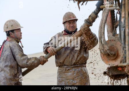 200117 -- XAYAR , Jan. 17, 2020 -- Drillers work at a drilling site in the Taklimakan Desert, northwest China s Xinjiang Uygur Autonomous Region, Jan. 13, 2020. Taklimakan Desert, nicknamed sea of death , is rich in oil and gas resources yet wracked by extremes of heat and cold. To explore the resources requires multiple processes including conducting geophysical survey, so as to collect seismic data to lay a solid foundation for further exploration. To perform the task, workers and researchers have to overcome various challenges and difficulties posed by nature. Every year nearly 2000 workers Stock Photo