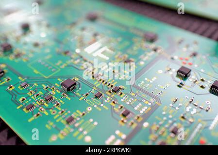 production of microelectronics in a modern industrial factory - motherboard with components in production Stock Photo