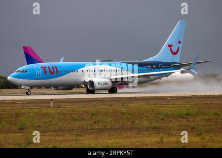 TUI Airways Boeing 737-8K5 (REG: G-TAWL) taking off after a shower. Stock Photo