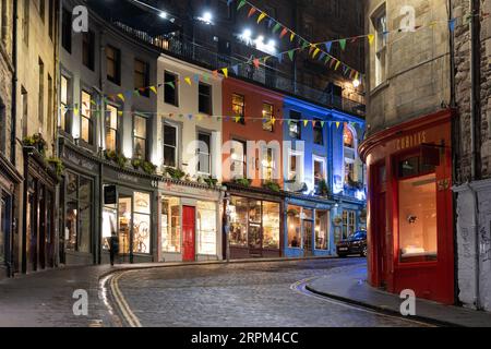 Edinburgh, Scotland, UK - May 8, 2023 - Victoria Street and West Bow at night in the Old Town with colorful buildings and retail stores, city landmark Stock Photo
