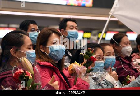 200129 -- TIANJIN, Jan. 29, 2020 -- The second batch of medical workers pose for a group photo before their departure to Wuhan of Hubei Province, at Binhai International Airport in Tianjin, north China, on Jan. 28, 2020. A team comprised of 138 members from 16 hospitals in Tianjin left for Wuhan on Tuesday to aid the coronavirus control efforts there.  CHINA-TIANJIN-MEDICAL TEAM-AID-SECOND BATCHCN MaxPing PUBLICATIONxNOTxINxCHN Stock Photo