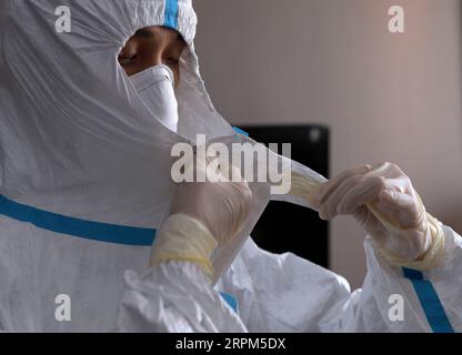 200130 -- WUHAN, Jan. 30, 2020 -- A medical worker from Beijing Anzhen Hospital practices how to put on and take off protective clothing for preparations to join the fight against the novel coronavirus epidemic at a base for medical workers in Wuhan, capital of central China s Hubei Province, Jan. 29, 2020. A team of 136 medical workers from 12 hospitals run by the Beijing municipal health commission flew to Wuhan on Monday, to join the fight against the coronavirus epidemic.  CHINA-HUBEI-WUHAN-MEDICAL TEAM CN CaixYang PUBLICATIONxNOTxINxCHN Stock Photo