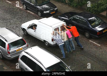 Netherlands, Car is pushed to start the engine, because the battery failed. Stock Photo