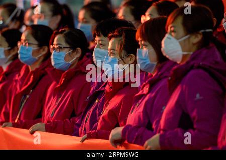 200205 -- URUMQI, Feb. 5, 2020 -- Medical team members are seen on a ceremony before leaving for Wuhan, the epicenter of the coronavirus outbreak, in Urumqi, northwest China s Xinjiang Uygur Autonomous Region, Feb. 4, 2020. The second batch of a medical team comprised of 102 members from Xinjiang left for Wuhan on Tuesday to aid the novel coronavirus control efforts there. So far, Xinjiang has sent a total of 244 medics to Wuhan.  CHINA-XINJIANG-MEDICAL TEAM-AID-SECOND BATCH CN DingxLei PUBLICATIONxNOTxINxCHN Stock Photo