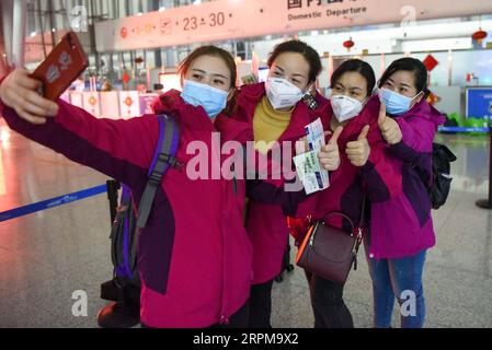 200205 -- URUMQI, Feb. 5, 2020 -- Medical team members take a selfie before leaving for Wuhan, the epicenter of the coronavirus outbreak, at Diwopu International Airport in Urumqi, northwest China s Xinjiang Uygur Autonomous Region, Feb. 4, 2020. The second batch of a medical team comprised of 102 members from Xinjiang left for Wuhan on Tuesday to aid the novel coronavirus control efforts there. So far, Xinjiang has sent a total of 244 medics to Wuhan.  CHINA-XINJIANG-MEDICAL TEAM-AID-SECOND BATCH CN DingxLei PUBLICATIONxNOTxINxCHN Stock Photo