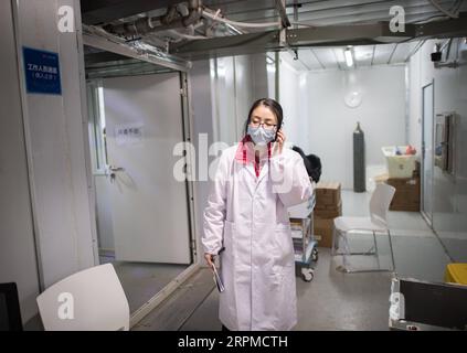 200208 -- WUHAN, Feb. 8, 2020 -- A nurse speaks on the phone at Leishenshan Thunder God Mountain Hospital in Wuhan, capital of central China s Hubei Province, Feb. 8, 2020. Medical workers at the Leishenshan Hospital are set to receive the first batch of patients of the novel coronavirus pneumonia on Saturday.  CHINA-HUBEI-WUHAN-LEISHENSHAN HOSPITAL-MEDICAL WORKERS CN XiaoxYijiu PUBLICATIONxNOTxINxCHN Stock Photo