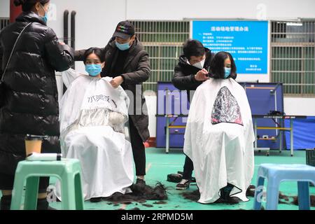 200209 -- BEIJING, Feb. 9, 2020 -- Medical team members have their hair cut to better wear protective products before leaving for Wuhan of Hubei Province, at the Third Xiangya Hospital of Central South University in Changsha, central China s Hunan Province, Feb. 8, 2020. Medical workers of the third batch from the Second Xiangya Hospital of Central South University and the first batch from the Third Xiangya Hospital of Central South University set off for Wuhan on Saturday, the Chinese Lantern Festival, to aid the novel coronavirus control efforts there.  XINHUA PHOTOS OF THE DAY ChenxZeguo PU Stock Photo