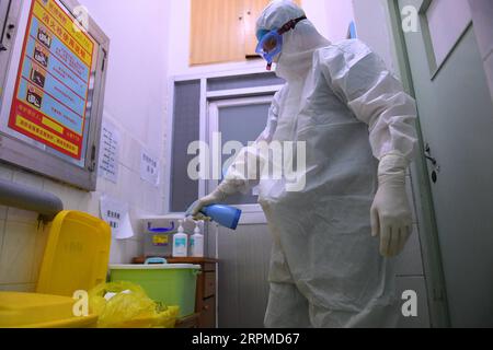 200209 -- CHANGSHA, Feb. 9, 2020 -- Yi Junfeng disinfects medical wastes at a fever clinic of Hunan People s Hospital in Changsha, central China s Hunan Province, Feb. 7, 2020. Amid the current novel coronavirus outbreak, 22-year-old male nurse Yi Junfeng has volunteered to join the battle against the epidemic. After a series of professional trainings, he now works as a front-line fever clinic nurse at Hunan People s Hospital in Changsha. Yi believes that a male nurse has comparative advantages in terms of physical strength and etc, and can play an important role in combating contagious diseas Stock Photo