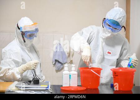 200209 -- CHANGSHA, Feb. 9, 2020 -- Yi Junfeng R prepares disinfectant solution at a fever clinic of Hunan People s Hospital in Changsha, central China s Hunan Province, Feb. 7, 2020. Amid the current novel coronavirus outbreak, 22-year-old male nurse Yi Junfeng has volunteered to join the battle against the epidemic. After a series of professional trainings, he now works as a front-line fever clinic nurse at Hunan People s Hospital in Changsha. Yi believes that a male nurse has comparative advantages in terms of physical strength and etc, and can play an important role in combating contagious Stock Photo