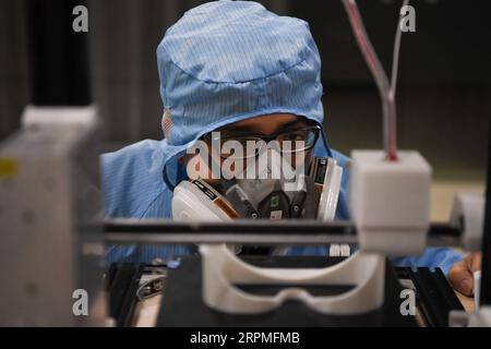 200211 -- CHANGSHA, Feb. 11, 2020 -- A worker inspects the operation of a 3D printer at the additive manufacturing research and application center of Hunan Vanguard Group Co., Ltd. in the economic development zone of Changsha City, central China s Hunan Province, Feb. 11, 2020. The company has been producing goggles for medical use with more than 50 3D printers working day and night recently. The first batch of 500 pairs of goggles it produced have been sent to Changsha and Huaihua to aid the novel coronavirus control efforts there.  CHINA-HUNAN-CHANGSHA-CORONAVIRUS-GOGGLES-3D PRINTING CN Xuex Stock Photo