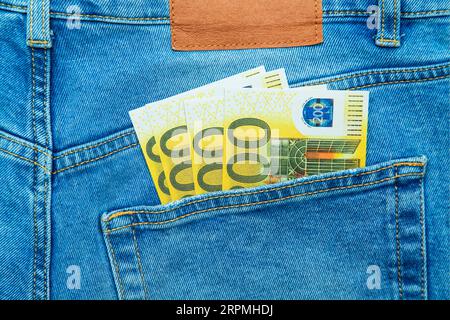 Money in the pocket of blue jeans. Two hundred euro banknotes. Stock Photo