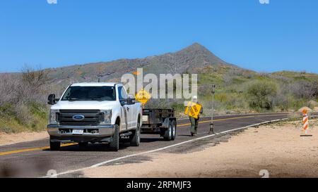 workers set up roadblocks after heavy rain due to massive flood damage, USA, Arizona, N Horseshoe Dam Rd, Scottsdale Stock Photo