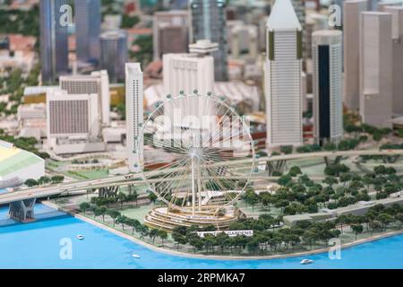 A detail urban planning view of Singapore Flyer against the tall commercial buildings in the background. Stock Photo