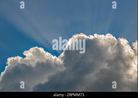 Rays of sunshine break through the clouds Stock Photo