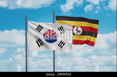 Republic of Uganda and South Korea flag waving together in the wind on blue sky, two country cooperation concept Stock Photo