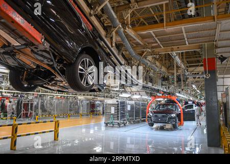 200217 -- CHANGCHUN, Feb. 17, 2020 -- Workers assemble Audi A6 L cars at a workshop of FAW-Volkswagen Automobile Co., Ltd. in Changchun, northeast China s Jilin Province, Feb. 17, 2020. A batch of black-colored Audi A6 L cars rolled off the production line on Monday. As the first batch of new cars produced at the FAW-Volkswagen Changchun base after the outbreak of novel coronavirus, it marked that the FAW-Volkswagen Automobile Co., Ltd., a passenger car joint venture between FAW and Volkswagen AG, officially resumed production. With thorough epidemic prevention and control measures, the joint Stock Photo