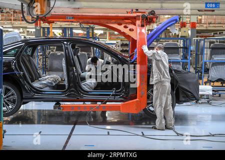 200217 -- CHANGCHUN, Feb. 17, 2020 -- Workers assemble Audi A6 L cars at a workshop of FAW-Volkswagen Automobile Co., Ltd. in Changchun, northeast China s Jilin Province, Feb. 17, 2020. A batch of black-colored Audi A6 L cars rolled off the production line on Monday. As the first batch of new cars produced at the FAW-Volkswagen Changchun base after the outbreak of novel coronavirus, it marked that the FAW-Volkswagen Automobile Co., Ltd., a passenger car joint venture between FAW and Volkswagen AG, officially resumed production. With thorough epidemic prevention and control measures, the joint Stock Photo