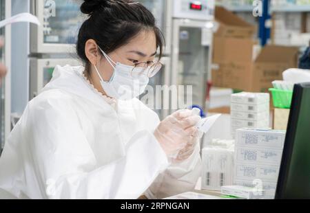 200228 -- WUHAN, Feb. 28, 2020 -- A pharmacy staff member dispenses medicines at the chain store of Hankou pharmacy in Huangshi Road of Wuhan, central China s Hubei Province, Feb. 27, 2020. This chain store of Hankou pharmacy is a designated pharmacy for medicines against chronic serious diseases. The staff members here often have to work from early morning to late night to meet the demand, dispensing an average of 1,000 orders comprising 30,000 packs of medicines each staff member per day.  CHINA-HUBEI-WUHAN-PHARMACY CN CaixYang PUBLICATIONxNOTxINxCHN Stock Photo