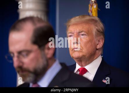 200229 -- WASHINGTON, Feb. 29, 2020 -- U.S. President Donald Trump R attends a press conference at the White House in Washington D.C., the United States, on Feb. 29, 2020. The United States on Saturday announced additional travel restrictions on Iran and raised travel advisories for certain areas of Italy and South Korea over coronavirus concerns.  U.S.-WASHINGTON D.C.-PRESS CONFERENCE-CORONAVIRUS LiuxJie PUBLICATIONxNOTxINxCHN Stock Photo