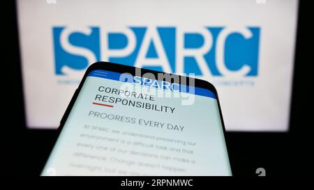 Smartphone with website of US retail company SPARC Group LLC on screen in front of business logo. Focus on top-left of phone display. Stock Photo