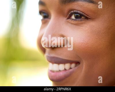 Close Up Portrait Of Smiling Beautiful Woman Standing Outdoors Stock Photo