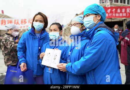 200308 -- WUHAN, March 8, 2020 -- Medical workers of the Wuhan Livingroom makeshift hospital pose for a group photo in Wuhan, central China s Hubei Province, March 8, 2020. The Wuhan Livingroom makeshift hospital officially closed on Sunday.  CHINA-HUBEI-WUHAN-MAKESHIFT HOSPITAL-CLOSE CN RaoxLiwen PUBLICATIONxNOTxINxCHN Stock Photo