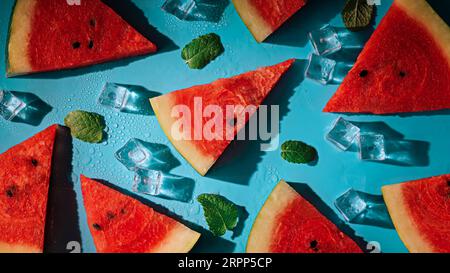Creative summer composition with watermelon, mint leaves, can of soda and ice cubes. Top down minimal watermelon drink concept. Stock Photo