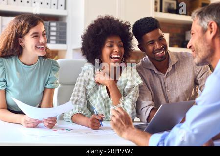 Male And Female Business People With Laptop Meeting In Modern Office Stock Photo