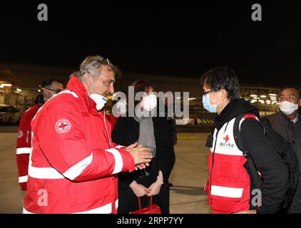 200312 -- ROME, March 12, 2020 -- Francesco Rocca L, Front, National President of the Italian Red Cross Association, welcomes a Chinese aid team at Fiumicino Airport in Rome, Italy, on Match 12, 2020. A charter flight carrying a nine-member Chinese aid team, along with tonnes of medical supplies, arrived at Fiumicino Airport on Thursday night, in part of China s efforts to help Italy contain the novel coronavirus outbreak.  ITALY-ROME-CORONAVIRUS OUTBREAK-CHINESE AID TEAM-ARRIVAL ChengxTingting PUBLICATIONxNOTxINxCHN Stock Photo