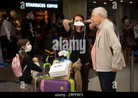 200313 -- EZEIZA, March 13, 2020 Xinhua -- Passengers wearing face masks are seen at the Ministro Pistarini International Airport in Ezeiza, Argentina, March 12, 2020. In Argentina where a total of 31 COVID-19 cases have been reported, a number of sports events, including football matches, will be held without spectators, according to the country s sports ministry. Xinhua/Martin Zabala ARGENTINA-EZEIZA-COVID-19 PUBLICATIONxNOTxINxCHN Stock Photo