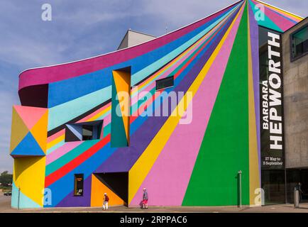 people walk past the Towner Art Gallery with colourful Dance Diagonal artwork by German artist Lothar Götz at Eastbourne, East Sussex, UK in September Stock Photo