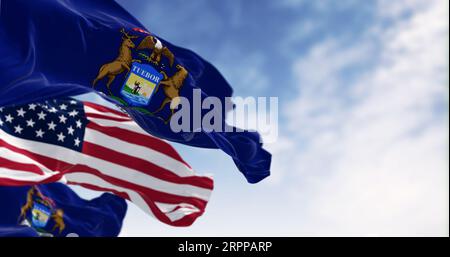 Flags of Michigan and the United States waving in the wind on a clear day. Patriotism and identity concept. 3d illustration render. Rippled fabric. Se Stock Photo