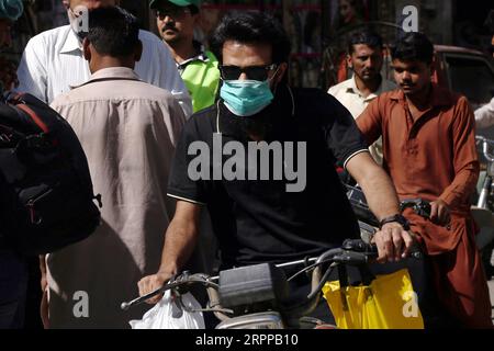 200314 -- KARACHI, March 14, 2020 Xinhua -- A man wearing face mask rides a motorbike in southern Pakistani port city of Karachi on March 14, 2020. The government of Pakistan has announced to upgrade its measures against COVID-19 across the country after 28 people tested positive of the virus during the last 17 days, Special Assistant to the Prime Minister on Health Zafar Mirza told media here Friday night. The country has banned all kinds of public gatherings, including sports and cultural festivals, recreational gatherings at cinemas and theaters, marriage ceremonies at halls or open places, Stock Photo