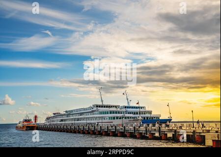 Cruise motor ships moored at the pier at sunset. Excursion tours on rivers and lakes of Russia. Stock Photo