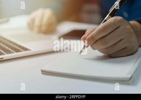 Hands Writing with Pen on Notebook. concept of work, study, and education. Stock Photo