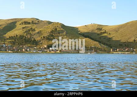 Town of Puno on Titicaca Lake Shore View from Cruise Ship, Puno, Peru, South America Stock Photo