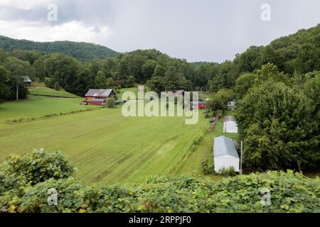 Small family farm in the mountains seen from the open air car of the Great Smoky Mountains Railroad on its excursion from Bryson City, North Carolina Stock Photo