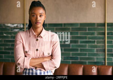 Portrait Of Serious Female Owner Or Member Of Staff Working In Coffee Shop Or Restaurant Stock Photo