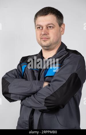 Portrait of a man in working overalls on a white background. Stock Photo