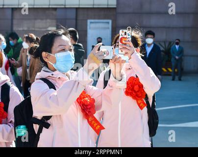 200319 -- TAIYUAN, March 19, 2020 -- Two medical workers take photos as they arrive at Wusu International Airport in Taiyuan, north China s Shanxi Province, March 19, 2020. Two batches of the medical assistance team from Shanxi, which consist of 230 members, had left Hubei Province as the epidemic outbreak in the hard-hit province has been subdued.  CHINA-SHANXI-TAIYUAN-COVID-19-MEDICS-RETURN HOME-ARRIVAL CN ChaixTing PUBLICATIONxNOTxINxCHN Stock Photo