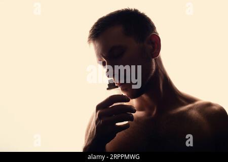 Men's perfume. Man holds perfume Stock Photo